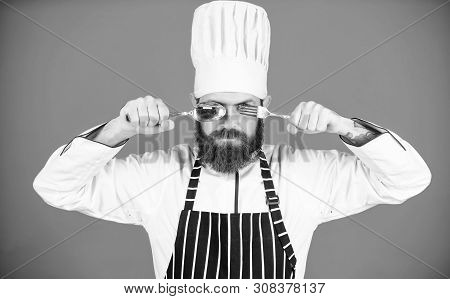 Time To Try Taste. Chef Serious Strict Face Hold Spoon And Fork. Man Handsome With Beard Holds Kitch