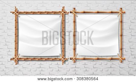 Blank White Canvas In Bamboo Frames Set . Picture Or Photo Square Frames Isolated On Brick Wall Back