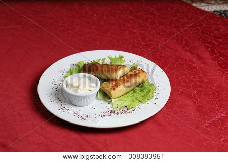 Blinchik, Crepes Stuffed With Meat, Potatoes, Eggs And Served With Yogurt Sauce And Lettuce. Image