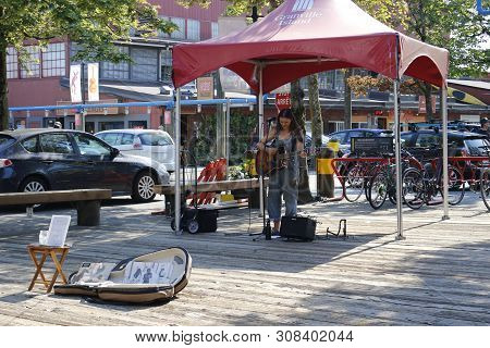 June 19 2018, Vancouver Canada: Editorial Photograph Of A Female Busking On Granville Island. Buskin