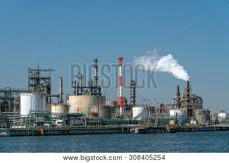 Scene Of Oil Refinery Industial Zone Beside The River On Working Hour Which Have Steam Smoke, Factor