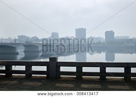 Pyongyang City View At Dawn, Capital Of The North Korea. Bridge Over Taedong River In Morning Fog