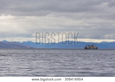 View Of The Avacha Bay. Ships Standing In The Roadstead, Mountain In The Background. Petropavlovsk-k