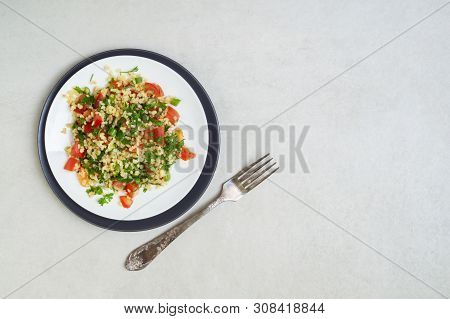 Lebanese Traditional Salad Taboule Made Of Parsley, Mint, Lemon, Tomatoes, Olive Oil, Salt And Peppe