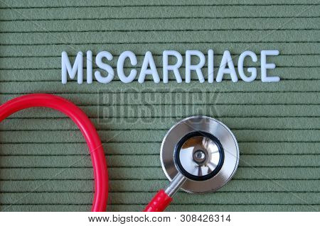Miscarriage- Text From White Letters On  Green Background With  Stethoscope, Medical Concept Diagnos