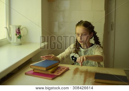 Pupil In School Uniform With Braids. Girl Schoolgirl At School With Book In School Uniform. Training