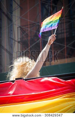 2018 JUNE 24 NEW YORK: NYC Pride March participants ride on a float adorned with rainbow flag material at 23rd St and 5th Ave.