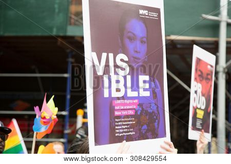 2018 JUNE 24 NEW YORK: NYC Pride March participant holds a sign that says Visible on the 5th Ave parade route.