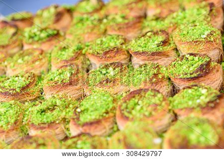 Honey Baklava Kadayif With Nuts Pistatio In The Market. Beautiful Arabic Sweet Background. Selective