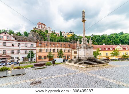 Plague Column Statue In Vranov Village, Czech Republic. View From Main Square To Vranov Castle Place