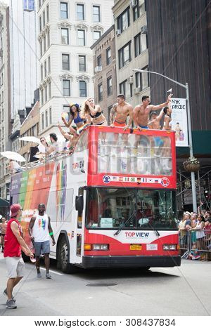 2018 JUNE 24 NEW YORK: NYC Pride March participants wearing only company brand underwear ride on the PVH parade float on 5th Ave route. Phillips-Van Heusen Corporation is an American clothing company.