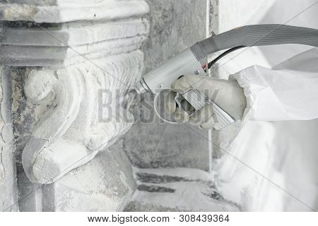 Hand Of Worker With The Gun For Serving A High-pressure Sand Jet. Professional Restoration Of Histor