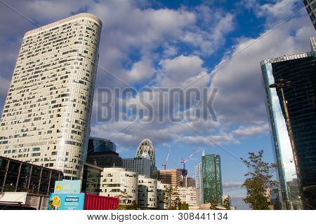 Bottom View Of The Glass Skyscrapers Of The Business District Of Paris La Defense Against A Blue Clo