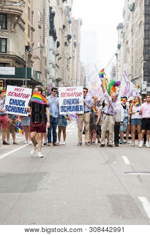 2018 JUNE 24 NEW YORK: Democratic Senate Minority Leader Chuck Schumer and supporters march along the 5th Ave parade route during the NYC Pride March.