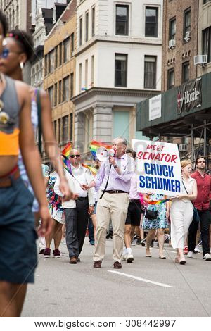 2018 JUNE 24 NEW YORK: Democratic Senate Minority Leader Chuck Schumer and supporters march along the 5th Ave parade route during the NYC Pride March.