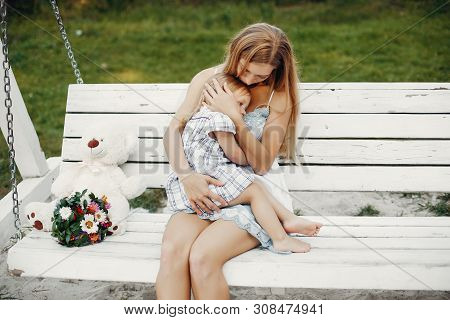 Mother With Daughter Playing In A Summer Park