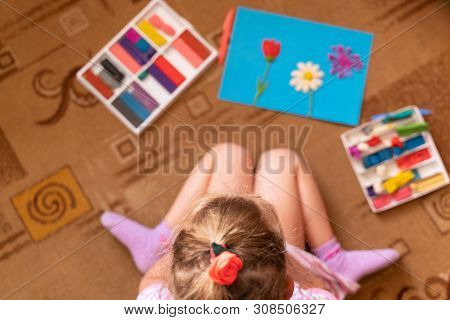 A Little Girl Plays And Sculpts From Clay. Modeling Of Plasticine And The Development Of Fine Motor