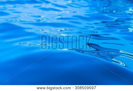 Calm Swirlling Blue Water Surface, Sea Or Ocean Abstract Background