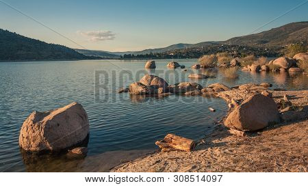 Valle Iruelas, Avila, Spain - April 7, 2014: View Of Some Rocks On The Shore Of The Lake In A Spring