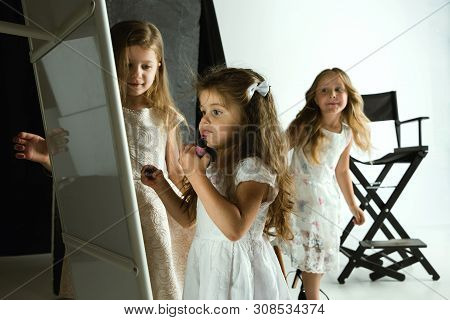 Interaction Of Children With Adult World. Cute Girls Trying To Do Bright Make Up For Being Older. Li
