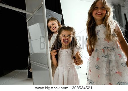 Interaction Of Children With Adult World. Cute Girls Trying To Do Bright Make Up For Being Older. Li