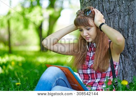 Woman Student Teenager Woman Clasped Her Hands Behind Her Head. Fright, Fear. Emotions When Preparin