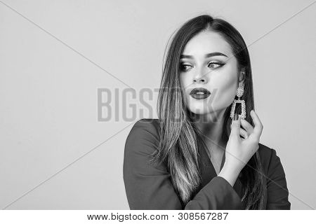 Jewelry Shop. Girl Model Long Hair Demonstrating Golden Jewelry Earrings. Expensive Accessory. Fashi