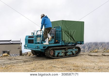 A Man Is Jumping To The Land Over Cross-country All Terrain Vehicle.