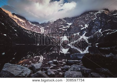 Spectacular View To The Beautiful Mountains With Mirroed Reflection And Clouds At Sunrise Time.