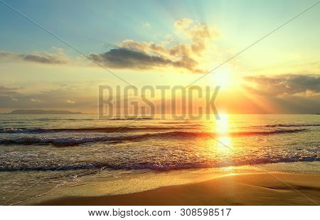 Golden Sunrise Sunset Over The Sea Ocean Waves. Rich In Dark Clouds, Rays Of Light