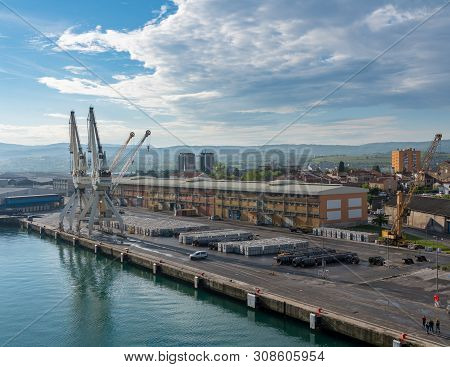 Koper, Slovenia - 24 May 2019: Cranes Line The Quayside In The Port Of Koper In Slovenia