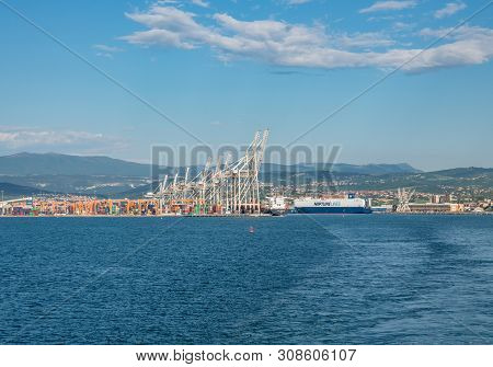 Koper, Slovenia - 24 May 2019: Cranes Load Containers Onto Ship In The Container Port Of Koper In Sl