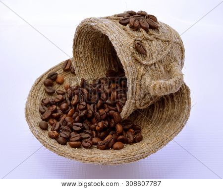 Сup And Saucer With Coffee Beans In It.