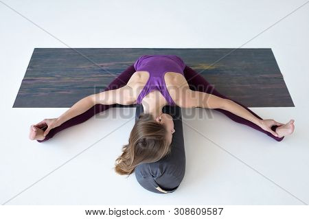 Caucasian Woman Doing Youga Splits Upavistha Konasana On Fitness Mat