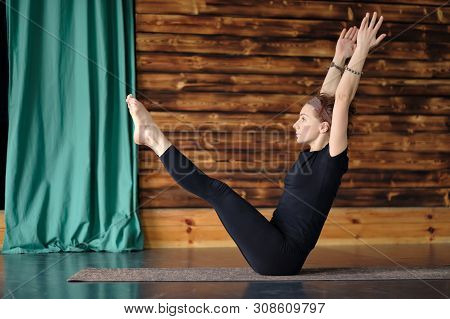 Woman Practicing Yoga, Sitting In Balance Exercise, Paripurna Navasana Pose
