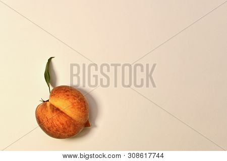 Ripe Yellow-red Peach With Green Leaf. With Half Longitudinal Division In Half. On A Light Backgroun