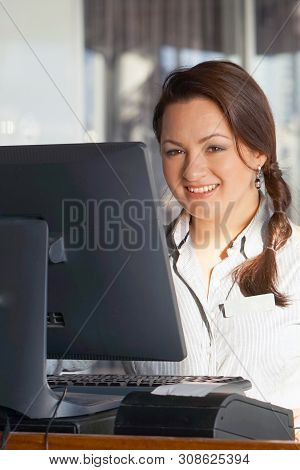 Bartender Registrating New Order By Cash Register. A Restaurant Waitress Registrating New Order By C