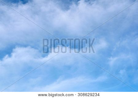 Blue Sky With Undulating Clouds. The Background Is Textured. For Any Purpose