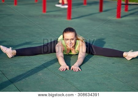 Stretching Gymnast Woman Doing Split, Twine In Workout Sports Ground