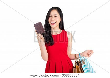 Beautiful Happy Asian Woman Holding Shopping Bags And Showing Passort In Another Hand, Studio Shot I