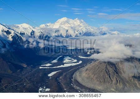 Aerial View Of Alaska Mountaion Range Around Denali Peak From A Plane With Glaciers Around And Blue 