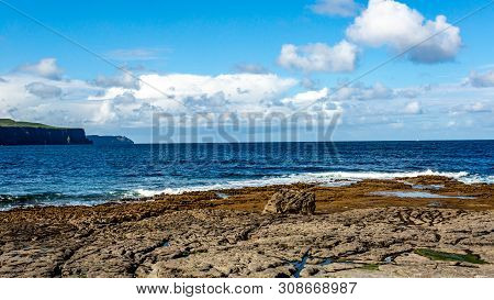 Doolin Bay With Stones And Calm Water With The Cliff De Moher In The Background, Wild Atlantic Way, 