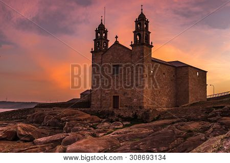 The Church Of Virgen De La Barca, Muxia, Galicia, Spain Shot At Sunset, Lots Of Orange And Purples I