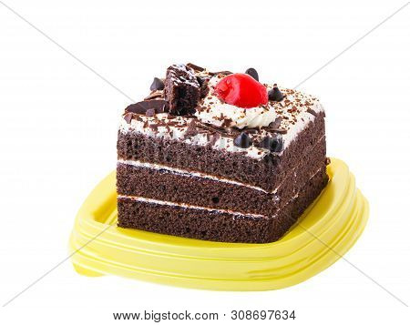 Chocolate Cake Is Covered With Whipped Cream And Decoreted By Red Cherry On Top