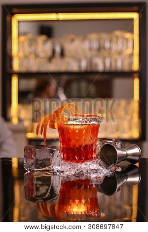 Barmen Making Negroni Alcohol Cocktail On Black Surface