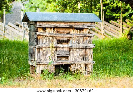 Very Old, Historical Empty Beehive In The Garden. Traditional Beehive From Old Times, Made Of Solid 