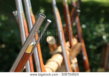 Stand With Ancient Rifles In A Summer Military Camp. Reconstruction Of Weapon Of The 19th Century