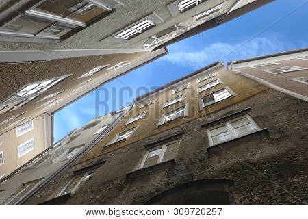 Dense Standing Buildings Bottom Up View In Typical West European City On Narrow Street