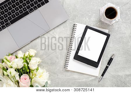 Office Desk Table With Laptop Computer, Blank Copy Space Mockup Screen Tablet, Flowers, Cup Of Coffe