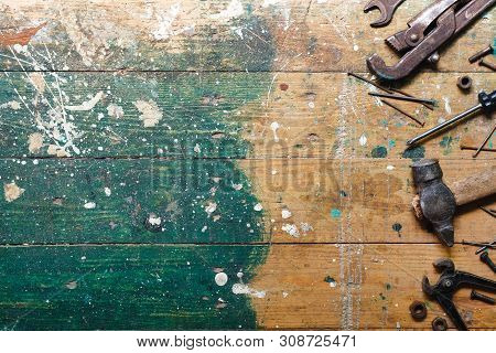 Flat Lay Set Of Vintage Carpentry Tools On Colorful Wooden Background. Top View Workbench With Carpe